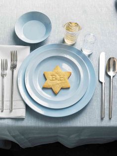 a plate with a star on it next to silverware and utensils,