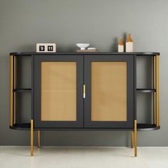 a sideboard with two doors and wicker panels on the front, against a gray wall