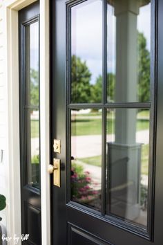 a black front door with two sidelights