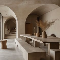 a long table with benches and vases on it