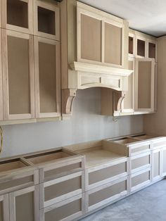 an unfinished kitchen with wooden cabinets and drawers