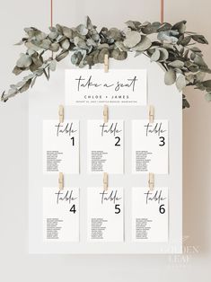 a table plan with eucalyptus leaves and wooden pegs