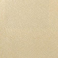 a close up view of the textured surface of a beige fabric with small dots