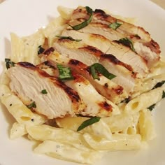 some chicken and pasta on a white plate