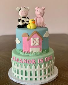 there is a cake decorated with farm animals on it