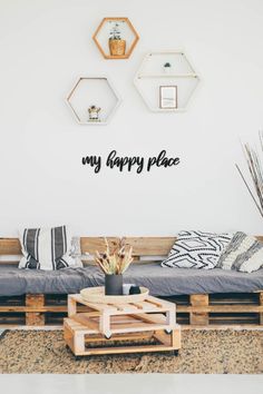 a living room filled with lots of furniture and decor on top of a wooden pallet