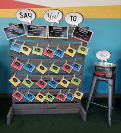 a display with signs and pictures on clothes pegs in front of a blue wall