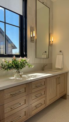 a bathroom with double sinks and large mirrors