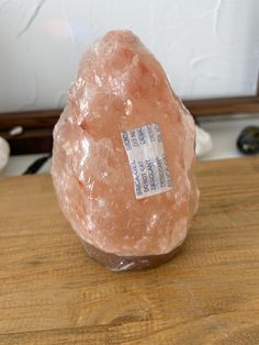 a pink rock sitting on top of a wooden table