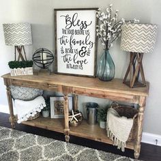 a shelf with some decorations on top of it next to two lamps and a sign