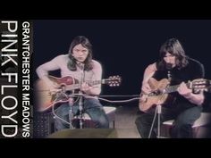 two men playing guitars on stage with microphones in front of them and the words pink floyd