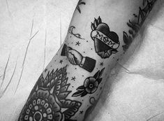 a black and white photo of a person's arm with some tattoos on it