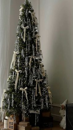 a decorated christmas tree with white lights and bows