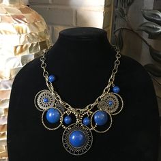 Bold And Blue! Statement Necklace With Stunning Blue/Indigo Detailing On A Single Chain Design. Comes With Matching Earrings (Picture To Come Soon). Still In Original Packaging. Necklace Worn Once, Earrings Never Worn. Elegant Blue Brass Necklace, Blue Brass Jewelry With Adjustable Chain, Blue Dangle Jewelry With Adjustable Chain, Blue Brass Round Jewelry, Blue Round Brass Jewelry, Blue Bohemian Round Jewelry, Bohemian Blue Round Jewelry, Adjustable Blue Costume Jewelry Necklace, Nickel-free Blue Bohemian Necklaces