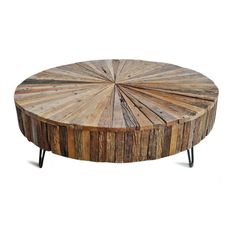 a wooden coffee table with black legs and a circular design on the top, made out of wood