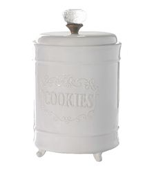 a white cookie jar sitting on top of a table