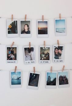 several polaroid photos hung on clothes pins and pinned to a white wall with pegs