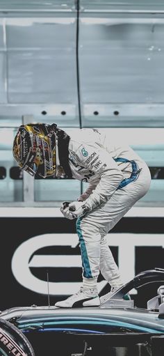 a man riding on the back of a racing car