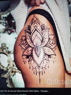 a woman's thigh with a tattoo design on it