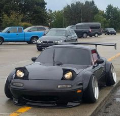 a black sports car parked in a parking lot