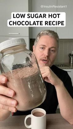 a man holding a jar filled with hot chocolate