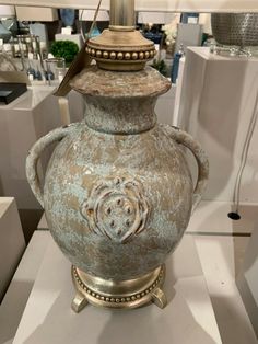 an old vase is on display in a store