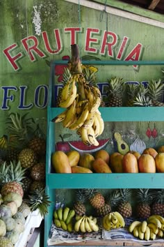 fruit stand with bananas, pineapples and other fruits