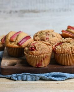 muffins with cranberry filling on a wooden cutting board