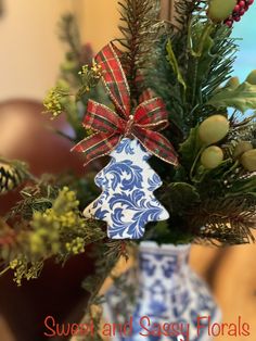 a blue and white vase with a christmas tree decoration