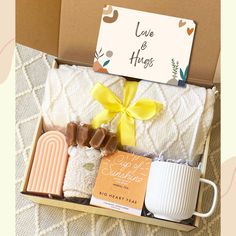 a gift box with coffee, marshmallows, and other items in it