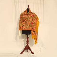 Mustard high-quality embroidered Kashmiri pashmina kashmiri wool shawl embellished with Kashmiri aari multicolored embroidery all over the piece. Perfect for formal occasions to add a pop of color to your outfits. These medium-length shawls are the perfect length to be styled with both eastern and western outfits. Dazzle up your wardrobe with a uniquely crafted fully embroidery shawl. Product specifications: Base color: Mustard Material: 100% Pashmina wool Washing instructions: Hand wash in cold water Dimensions:200cm by 70cm Shipping details: The product will be delivered to you between 5-10 working days. 1-2 days processing time for all orders. Now offering free shipping to your doorstep! Multicolor Embroidered Pashmina Shawl With Zari Work, Multicolor Pashmina Shawl With Chikankari Embroidery, Multicolor Embroidered Pashmina Shawl, Pashmina Shawl With Multicolor Embroidery In Traditional Drape, Traditional Pashmina Scarf For Weddings, Traditional Pashmina Scarves For Festive, Traditional Pashmina Scarves For Festive Occasions, Pashmina Shawl With Chikankari Embroidery, Embroidered Silk Shawl For Eid