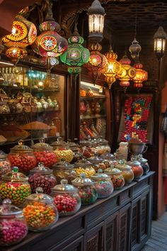 a store filled with lots of different types of candies and lights hanging from the ceiling