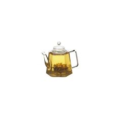 a glass tea pot filled with yellow flowers