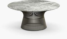 a round table with a marble top and metal mesh design on the base, against a white background