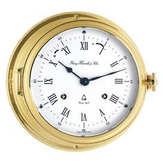 a gold clock with roman numerals on the face and numbers are shown against a white background