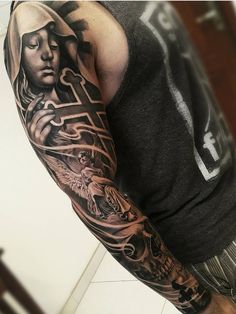 a man with a black and grey tattoo on his arm