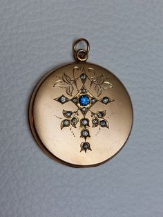 Beautiful Antique Statement Locket with fine engravings, blue, clear rhinestones, and monogram "TS" at the back. Details: The locket was made by the well-known W&H Company from the USA, which stopped operating in 1922. The logo of the company is stamped inside: W&H Co. inside a heart. It is not stamped for gold content but likely made of gold filled which was the typical material used for W&H Co. jewelry. Condition: It is in excellent antique condition, with gentle surface wear and scratches, an Antique Blue Diamond Jewelry, Victorian Blue Jewelry With Diamond Accents, Vintage Sapphire Jewelry With Diamond Accents, Formal Blue Locket Jewelry, Antique Diamond Jewelry With Screw Back, Blue Locket Jewelry For Anniversary, Antique Rhinestone Jewelry For Anniversary, Victorian Blue Locket Jewelry, Antique Style Rhinestone Jewelry For Anniversary