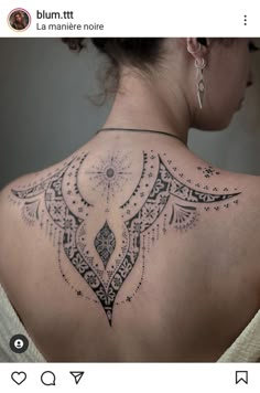 the back of a woman's shoulder with an intricate design on it