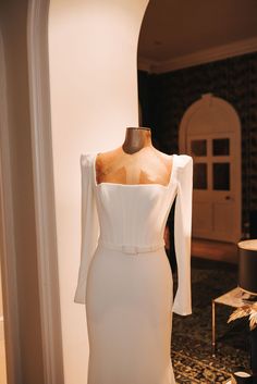 a white dress on display in a room