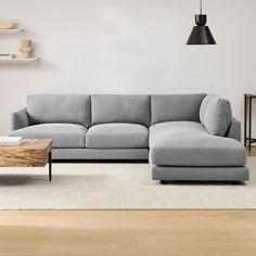 a living room with a couch, coffee table and lamp