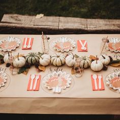 a table topped with lots of plates and pumpkins