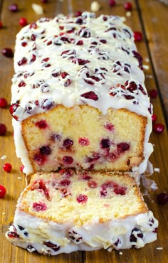 a loaf of cranberry pound cake with white frosting and cherries on top