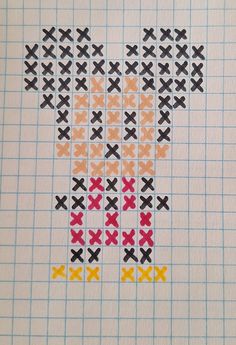 a cross stitch bear made out of different colored crosses on a piece of graph paper