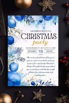 a christmas party flyer with ornaments and decorations on the table, including blue balls and greenery