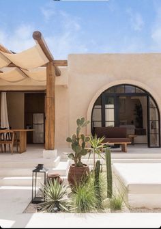 an outdoor patio with potted plants and chairs