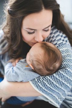 a woman holding a baby in her arms