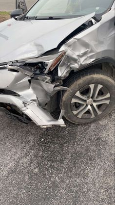 a silver car that has been involved in a accident with the front end of it