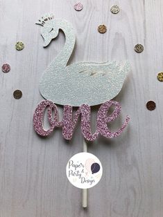 there is a cake topper that has a swan on it with the word love