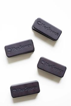 three black batteries sitting next to each other on a white surface, with the words airspace printed on them