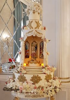 a wedding cake is decorated with flowers and figurines